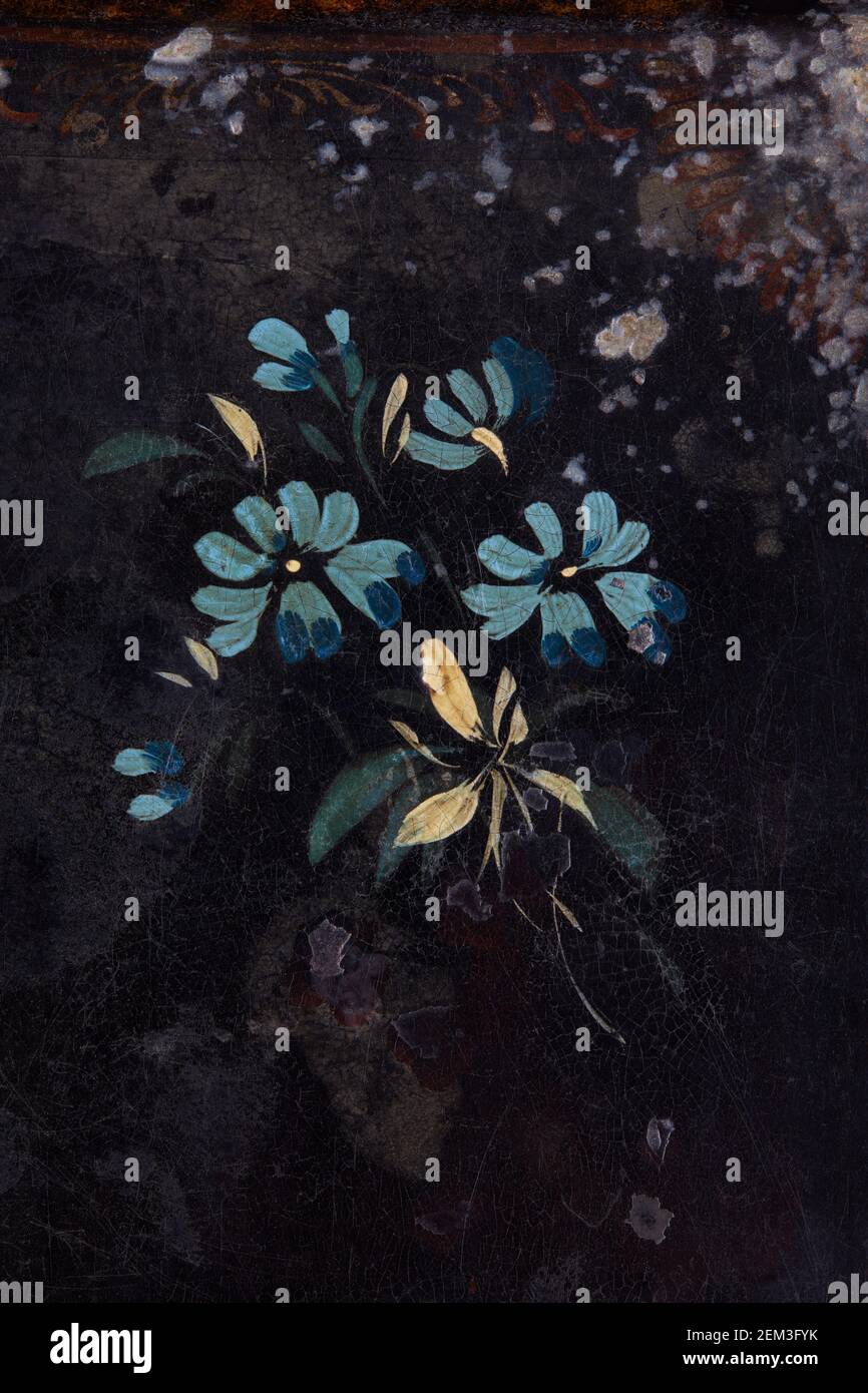 Blue flowers painted on black, ancient background Stock Photo