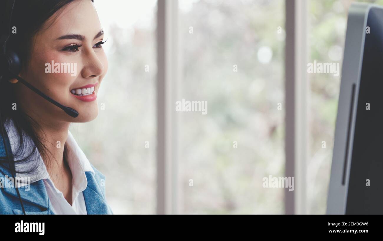 Customer support agent or call center with headset works on desktop