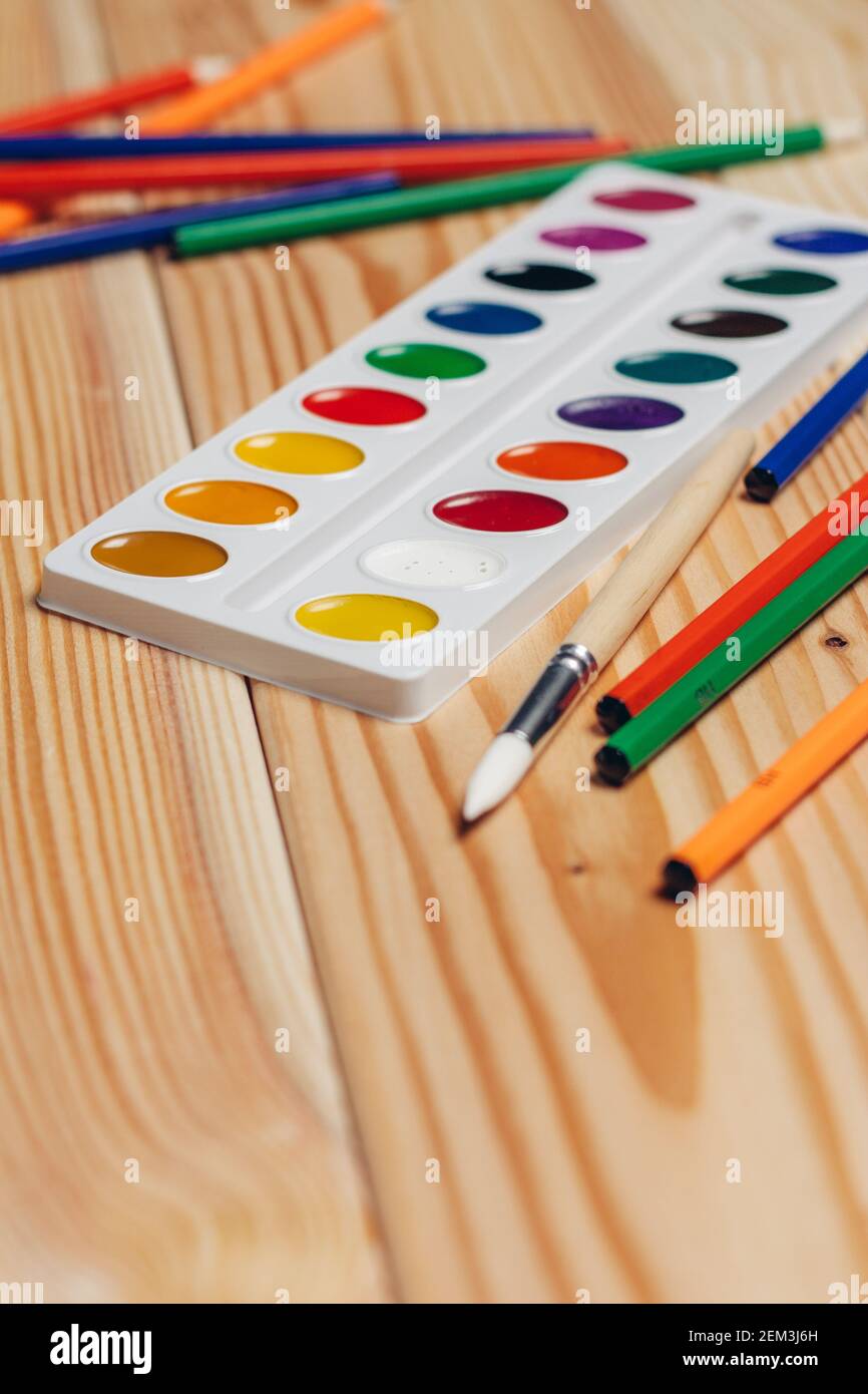 colorful pencils paint school supplies work desk closeup Stock Photo