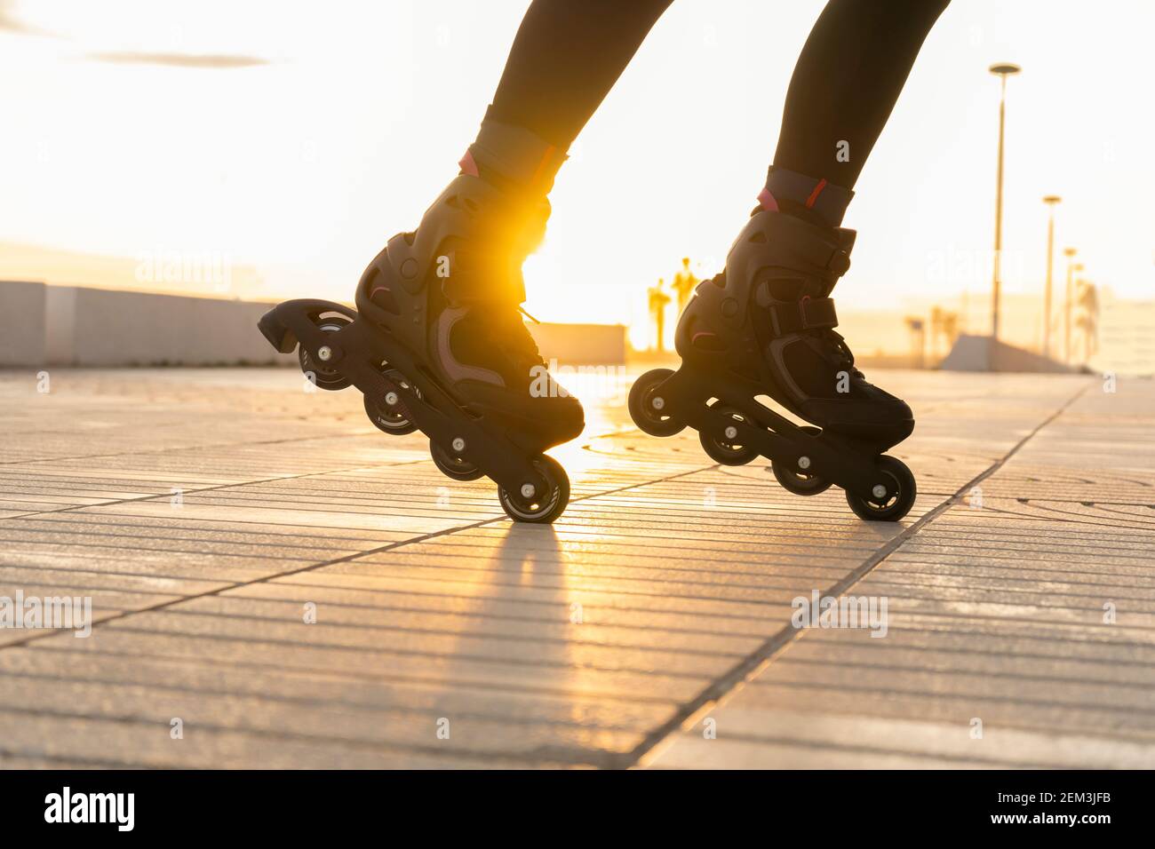 Closeup view of woman legs with roller skates at sunset.Creative sport and roller skating