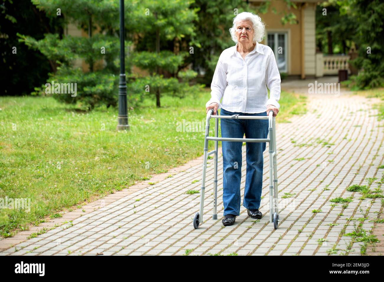 Elderly lady using a walking aid hi-res stock photography and images ...