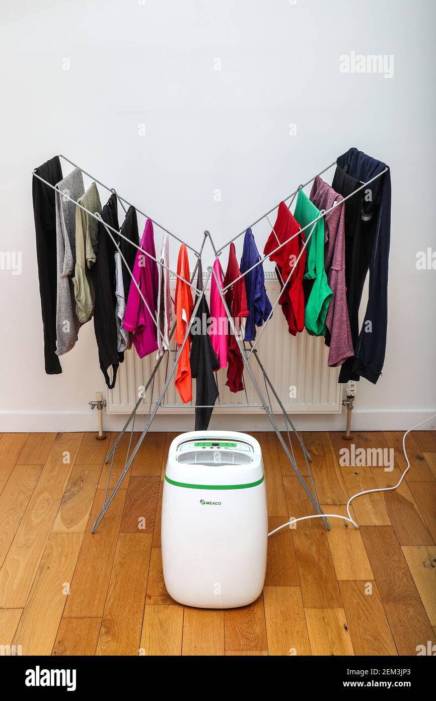 Dehumidifier drying clothes on an airer indoors Stock Photo