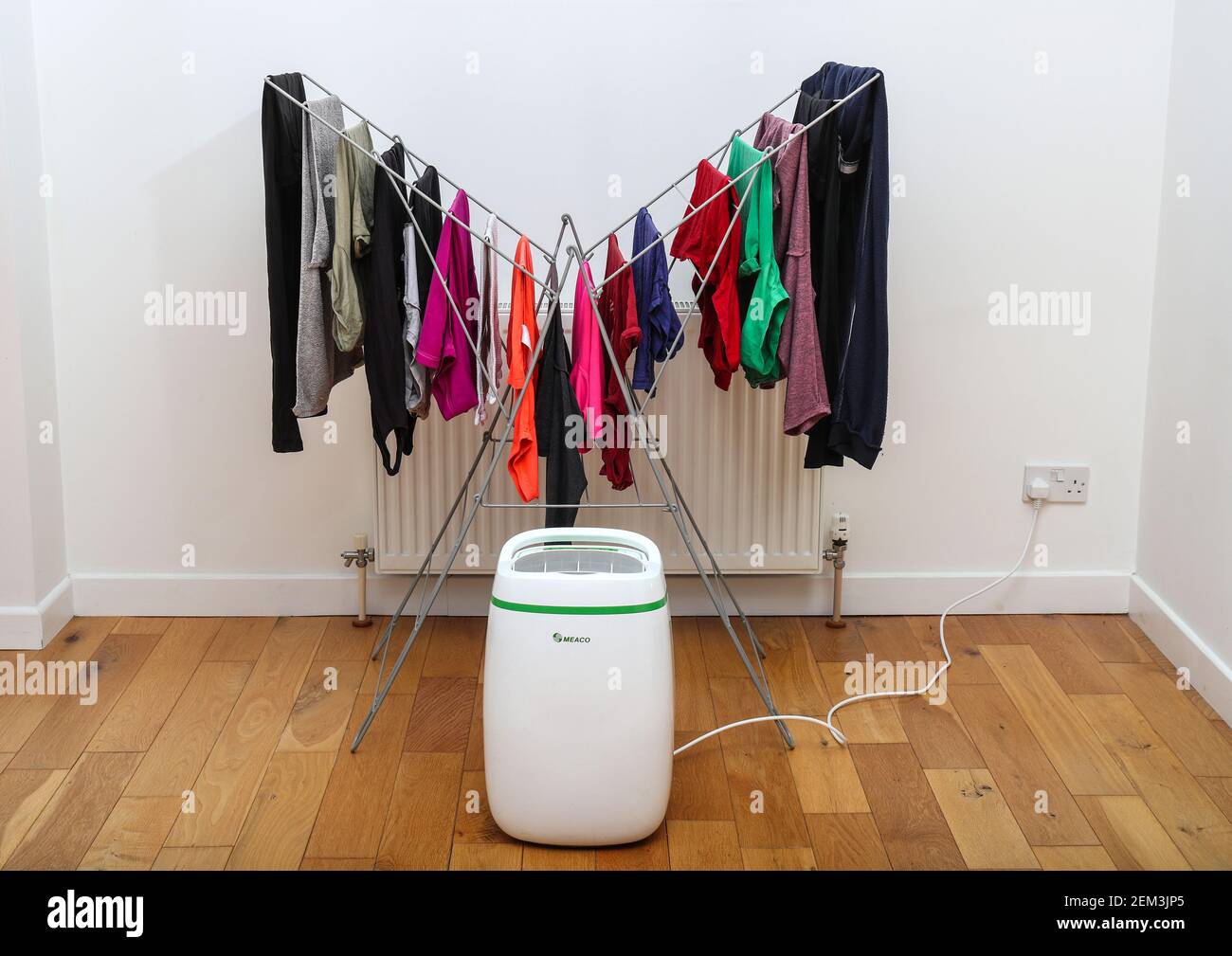 Dehumidifier drying clothes on an airer indoors Stock Photo