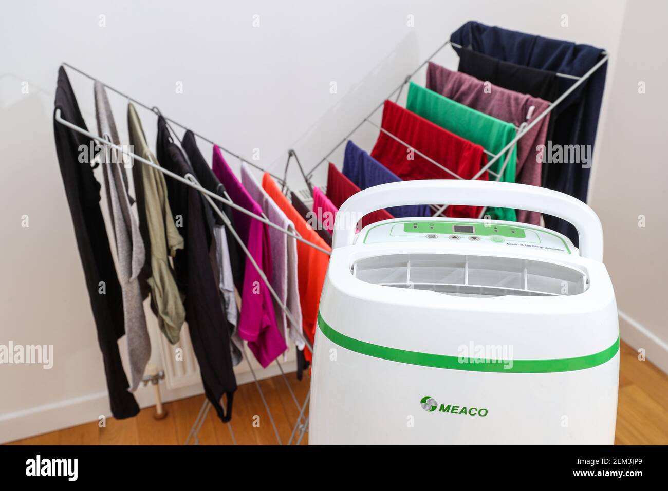 Dehumidifier drying clothes on an airer indoors Stock Photo