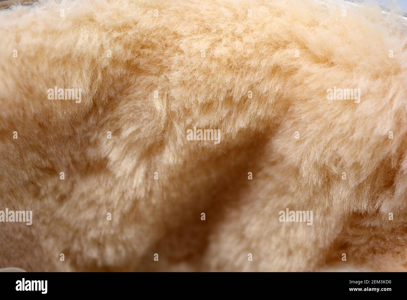 White light fur with wide fiber. Dense synthetic material. Warm, warming materials for winter things. Stock Photo