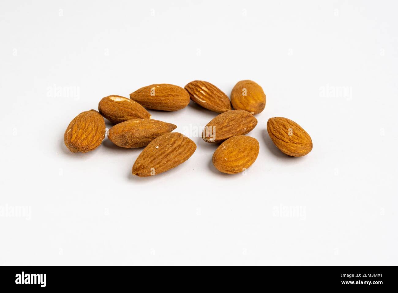 Heap of raw organic Californian almond nuts unshelled and without salt on a neutral background Stock Photo