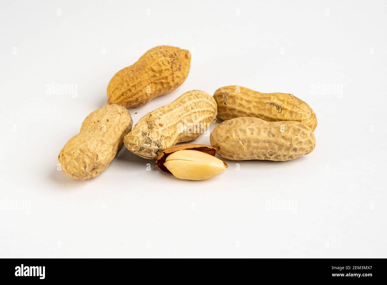 Heap of raw peanuts in shells without salt close up detail on neutral background Stock Photo