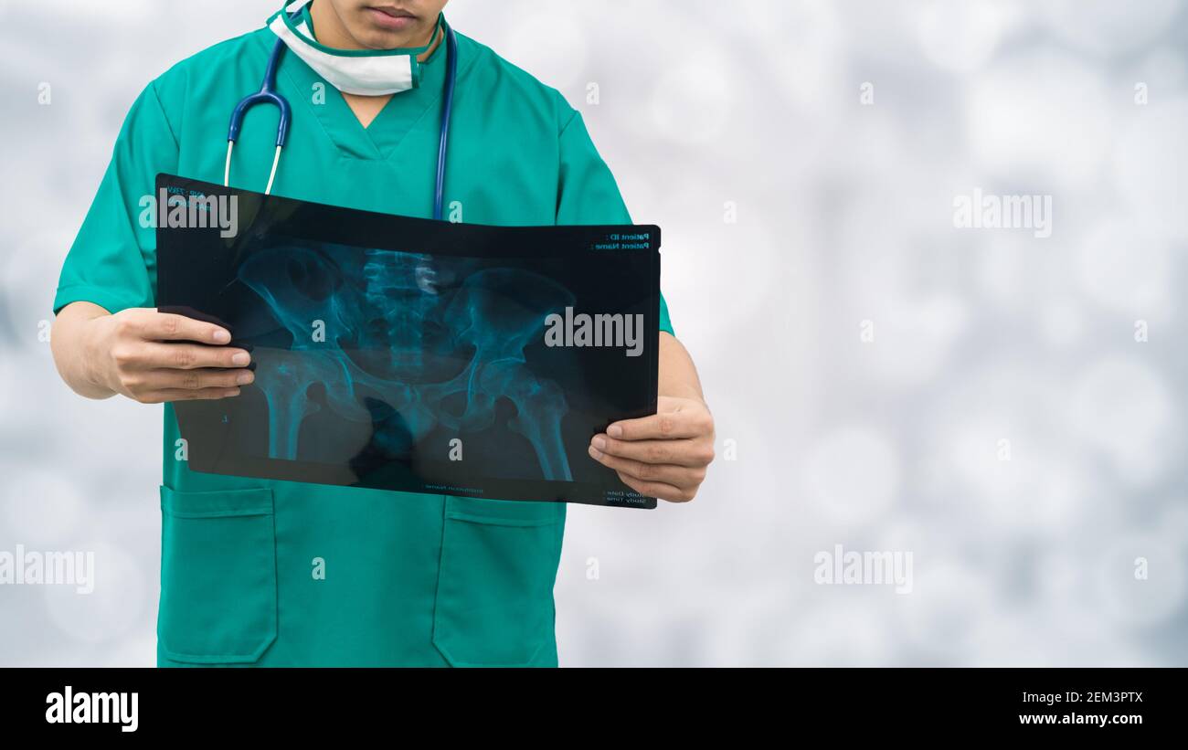 Surgical doctor examining xray film, diagnose patient 's waist bone. Surgery operation concept. Stock Photo
