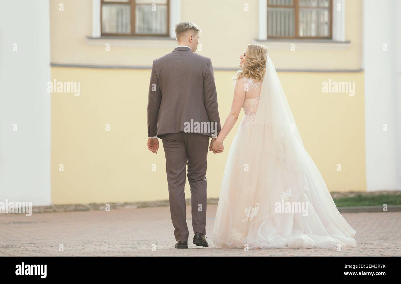 bride and groom walking down the street of the old town Stock Photo - Alamy
