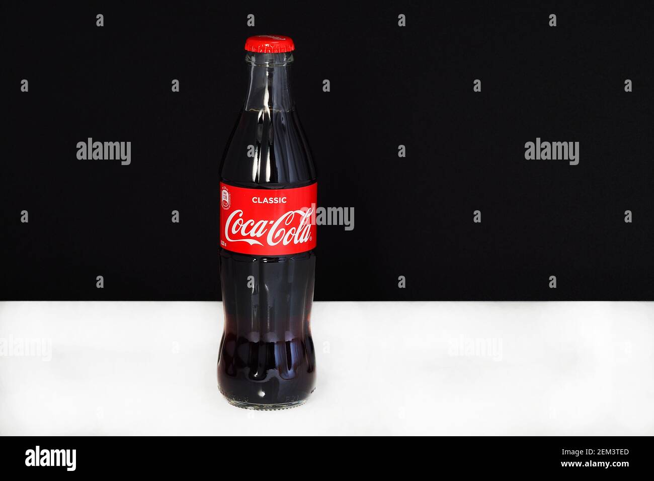 Coca cola in a glass bottle with the logo, isolated, on a black-and-white background. Editorial image. Russia, Nizhniy Stock Photo