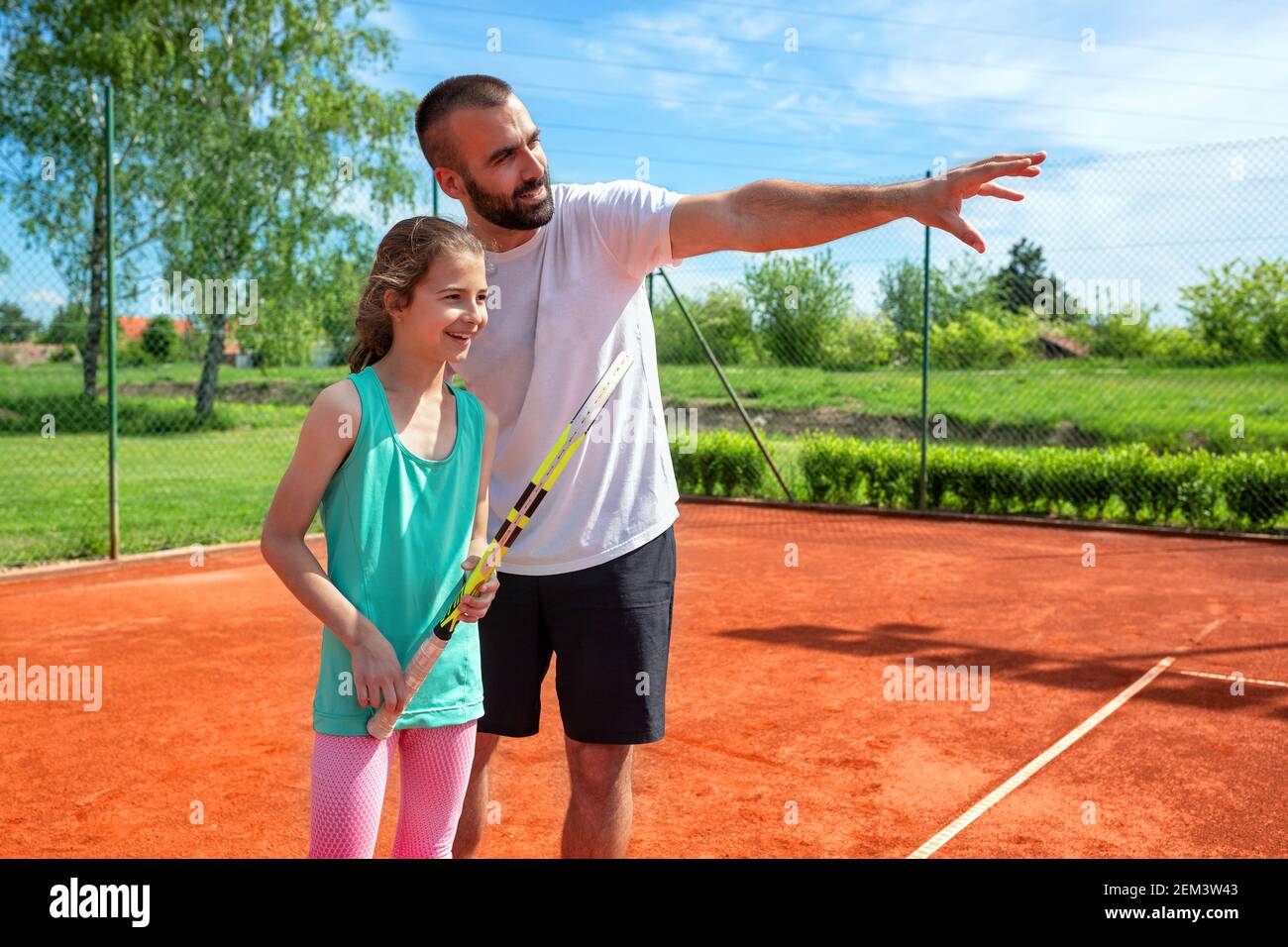 Tennis coach explaining to his student about some game details Stock