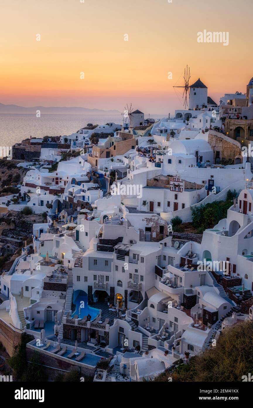 Oia village Santorini with blue domes and white washed house during sunset at the Island of Santorini Greece Europe, sunrise Santorini Stock Photo
