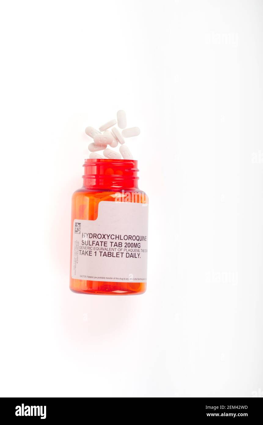 Hydroxychloroquine, common brand name Plaquenil, an immunosuppresive & anti-parasite drug prescription pill bottle open with pills showing Stock Photo