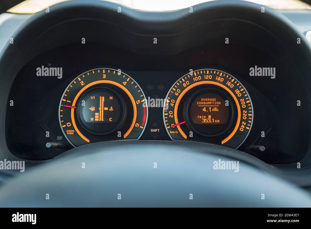 Car dashboard gauges with average fuel consumption Stock Photo Alamy