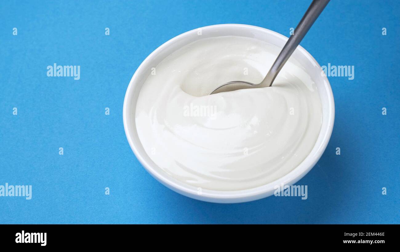 Bowl of sour cream, greek yogurt with spoon Stock Photo Alamy