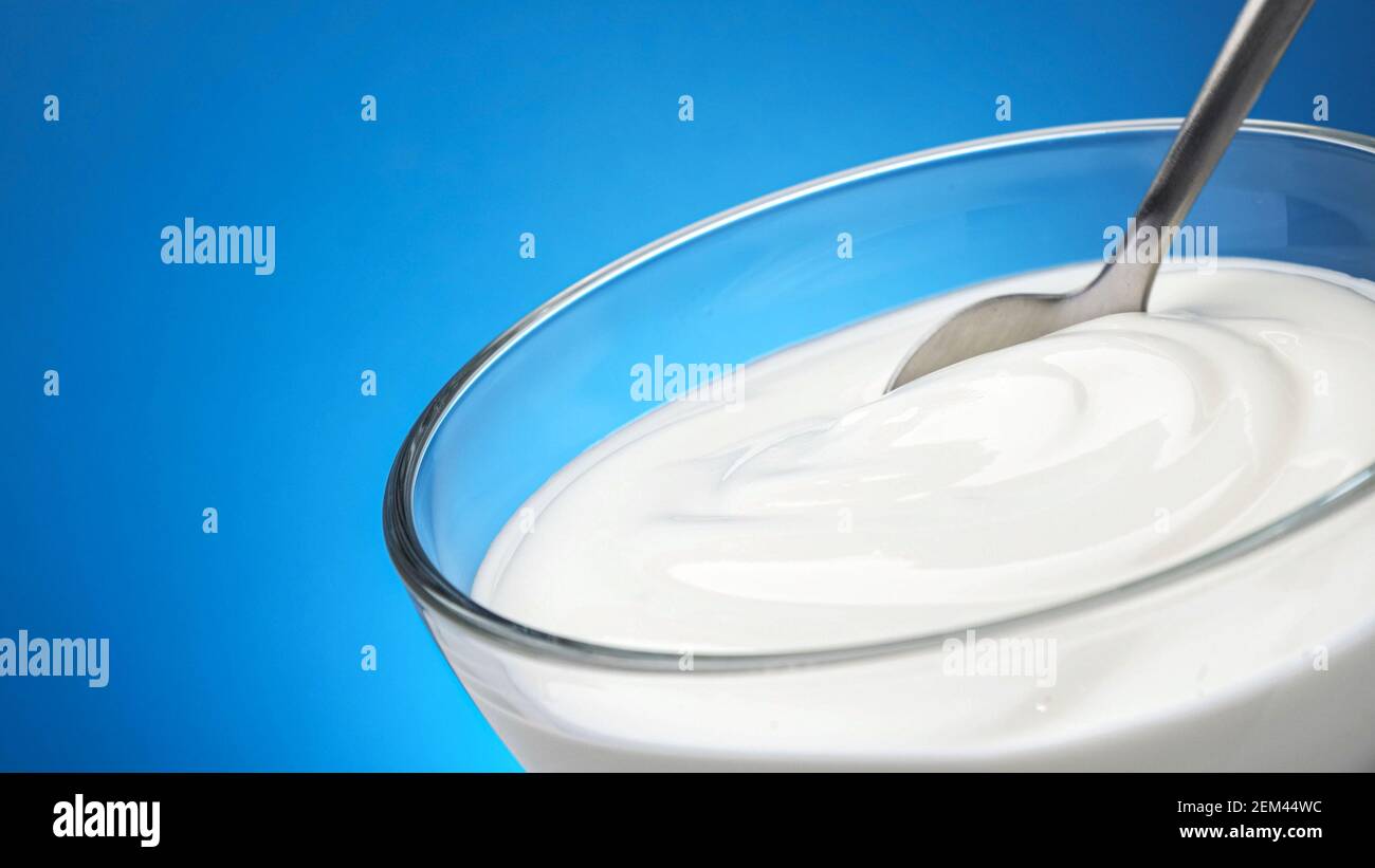 Bowl of sour cream, greek yogurt with spoon Stock Photo Alamy