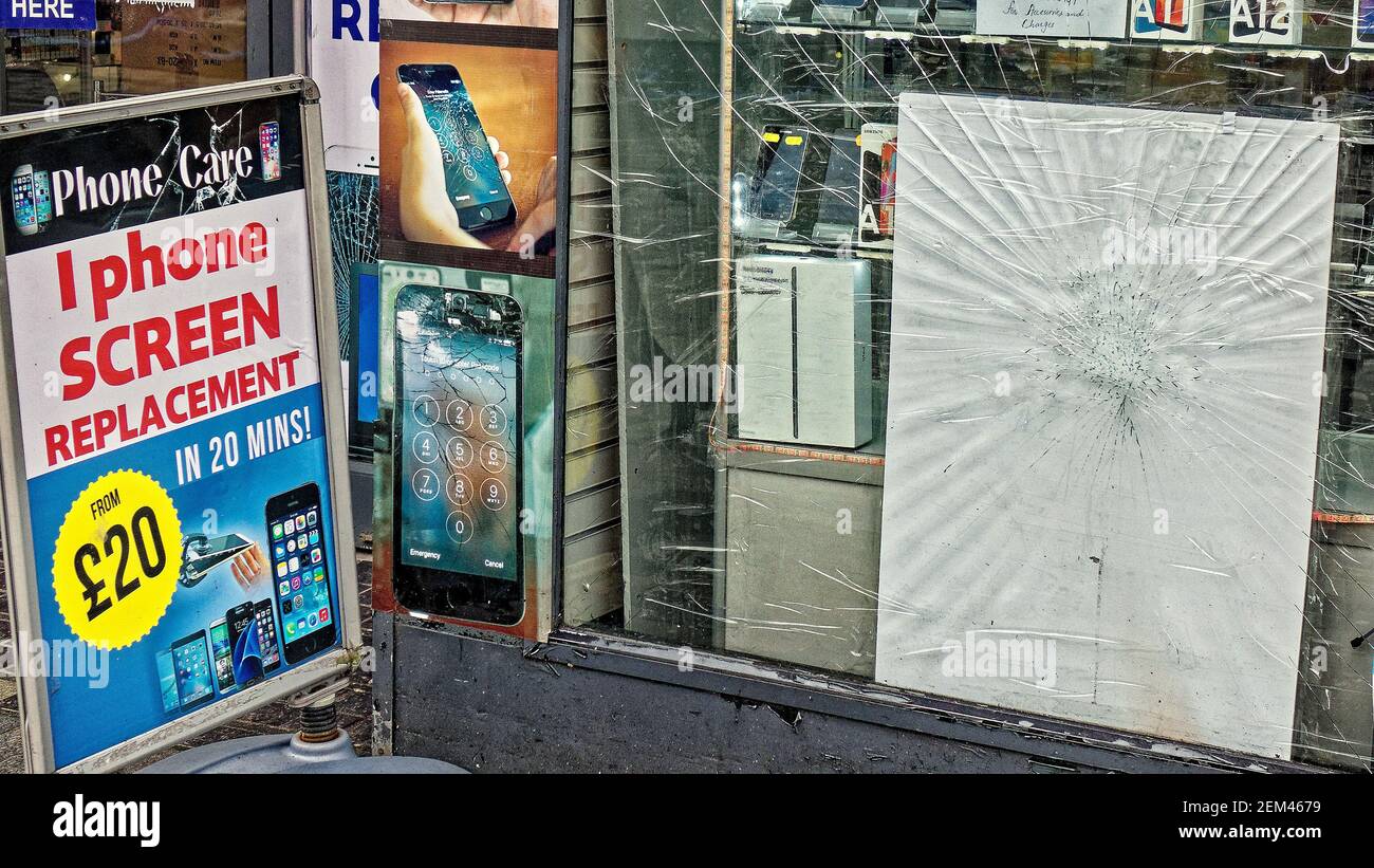 Glasgow, Scotland, UK, 24th February, 2021, Lockdown Wednesday saw increasing vandelism due to empty city centres ironically for this phone shop,  Credit Gerard Ferry/Alamy Live News Stock Photo
