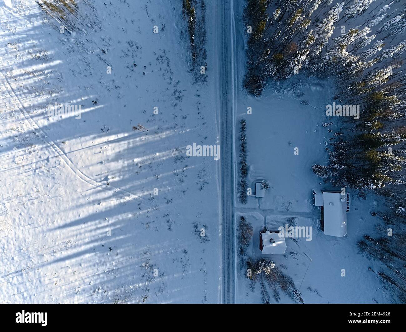 Long shadows and rural farm buildings in Sweden, shot with a drone from above. Stock Photo
