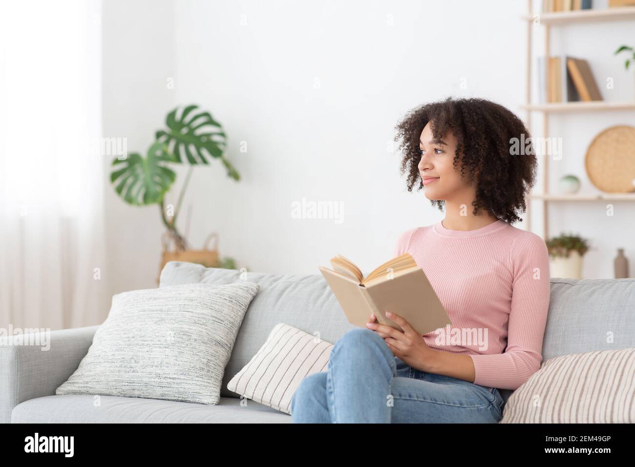 Serene pretty young african american woman feel relaxed, lady dream enjoy wellbeing breathing fresh air Stock Photo
