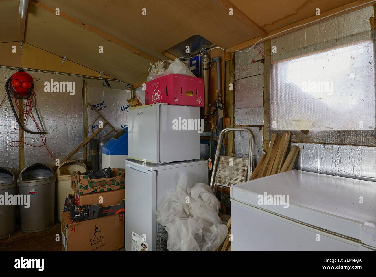 Freezer, deep freeze and fridge and various other items in the garden