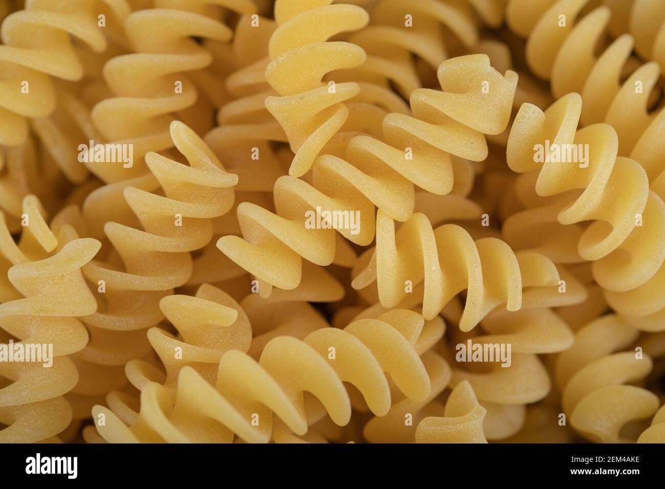 Raw dry Fusilli pasta as a background Stock Photo Alamy