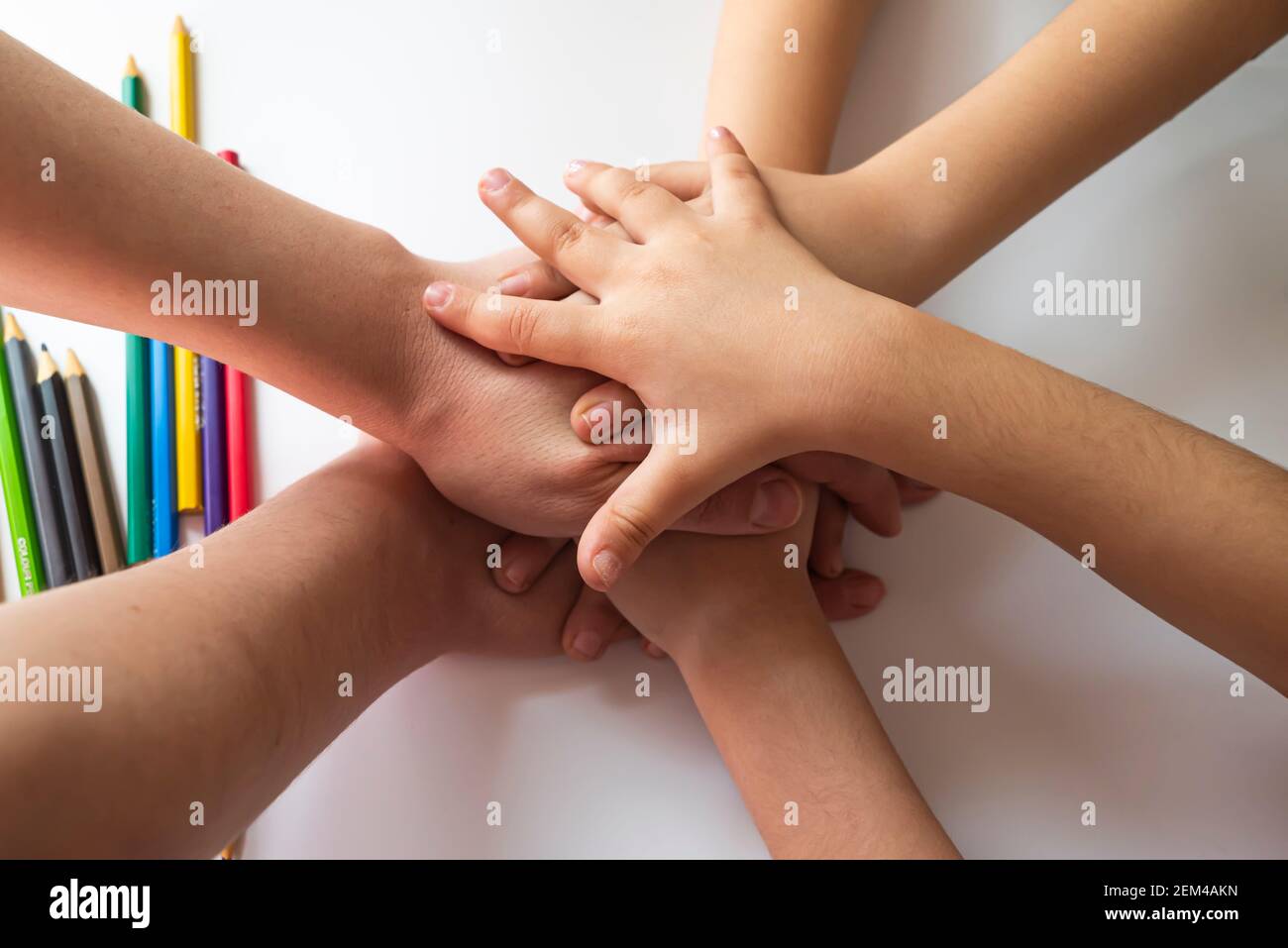 Togetherness message from small hands for 8 March, International Women's  Day. Small hands stacked on top of each other Stock Photo - Alamy