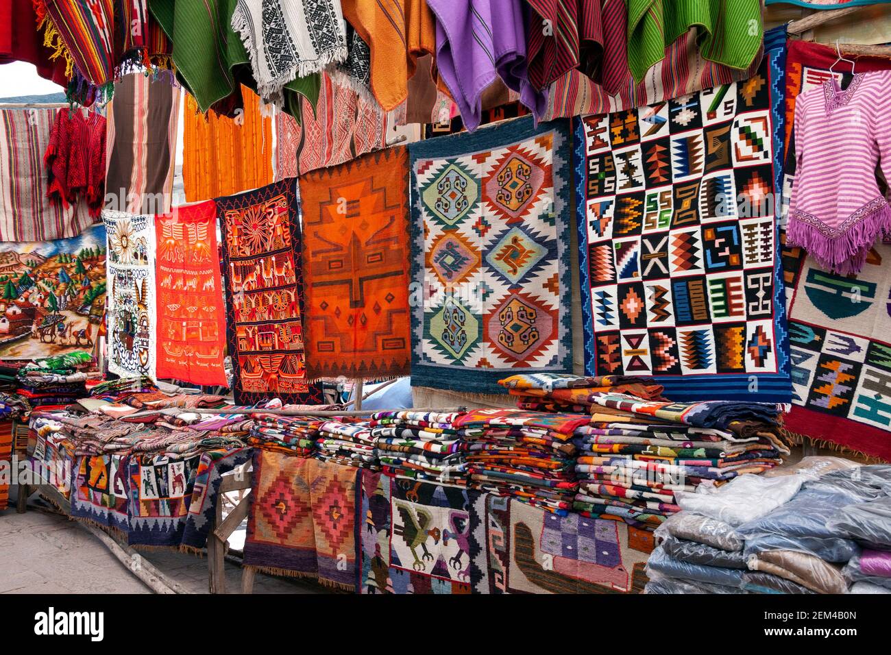 Pisac. Peru. 04.19.08. Local fabrics for sale on a market stall in the small town of Pisac in Urubamba Province, Peru in South America. Stock Photo