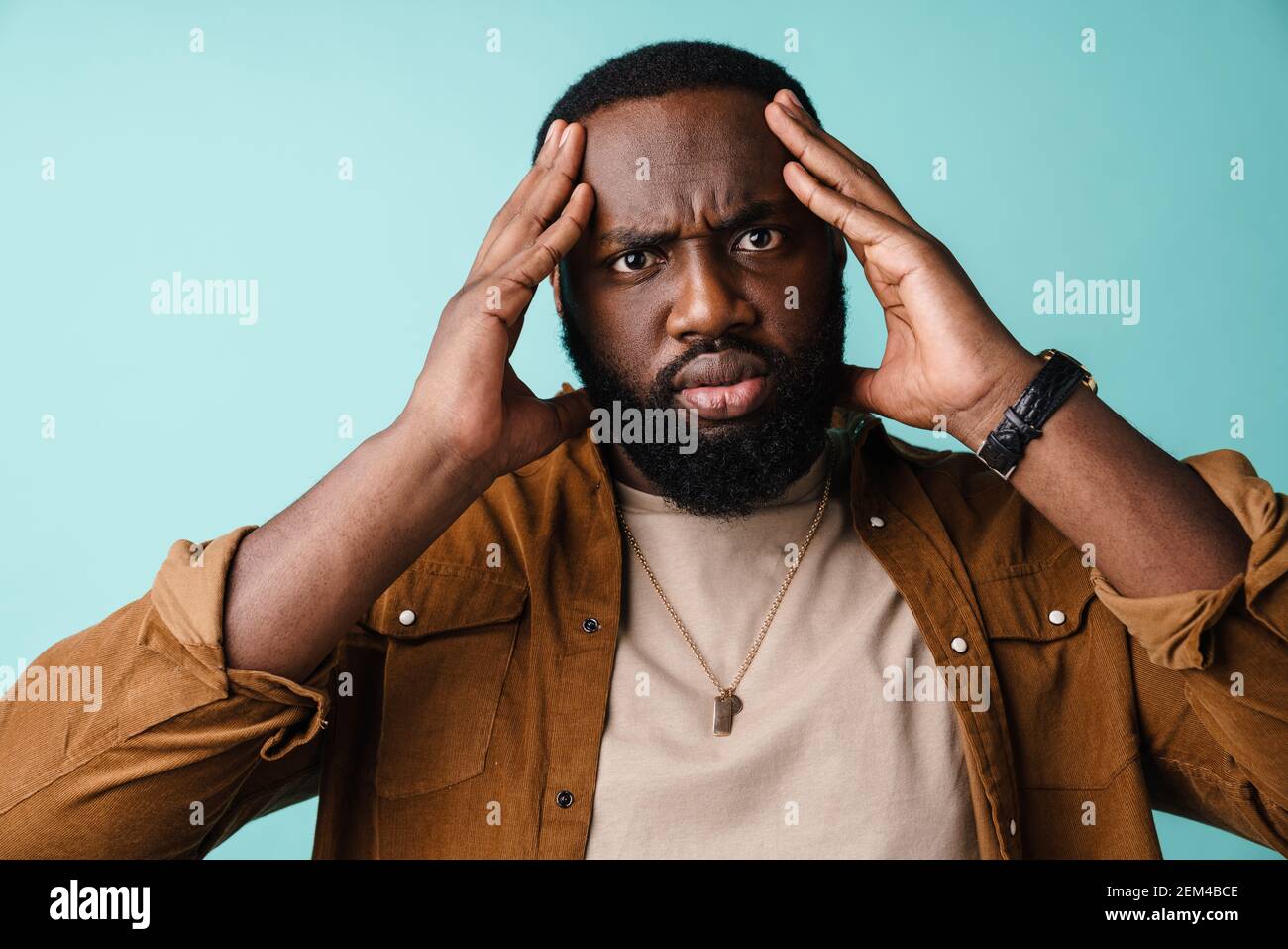 Angry upset african man standing isolated over blue background, casual ...