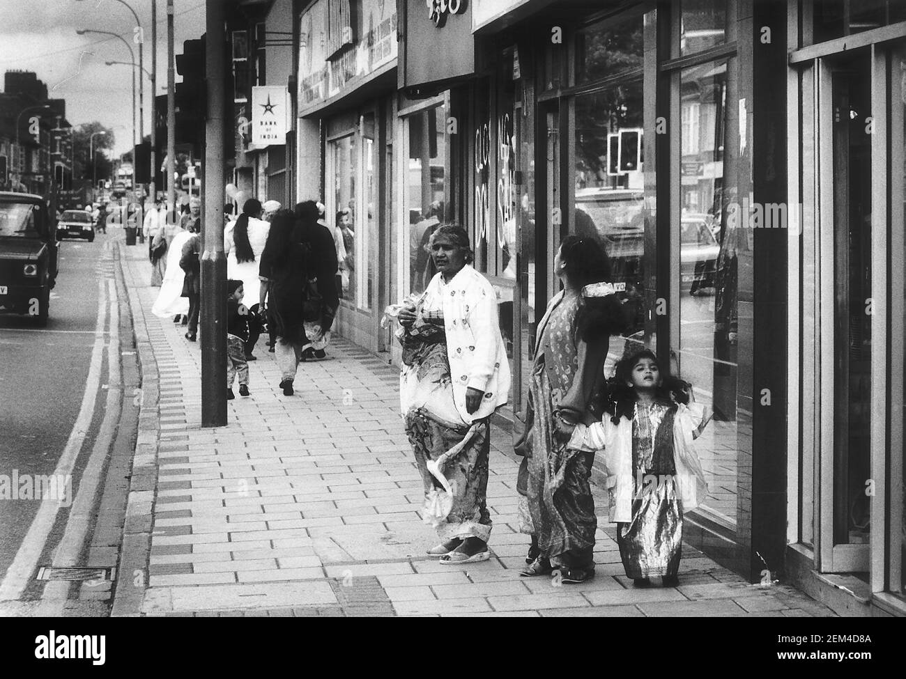 Belgrave Road in the Belgrave area of Leicester  August 1993with Asian family in street Stock Photo