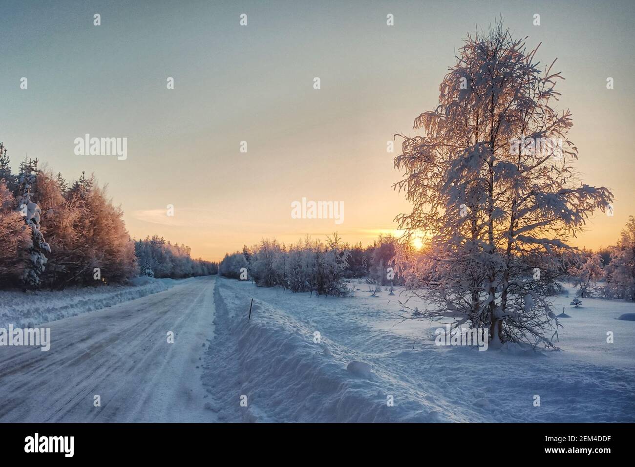HDR shot of winter sunrise and icy road in Swedish Lapland Stock Photo ...
