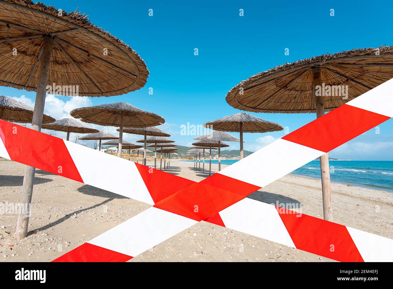 Empty beach with barrier tape, closed summer beach, concept picture about lockdown and pandemic in the world Stock Photo