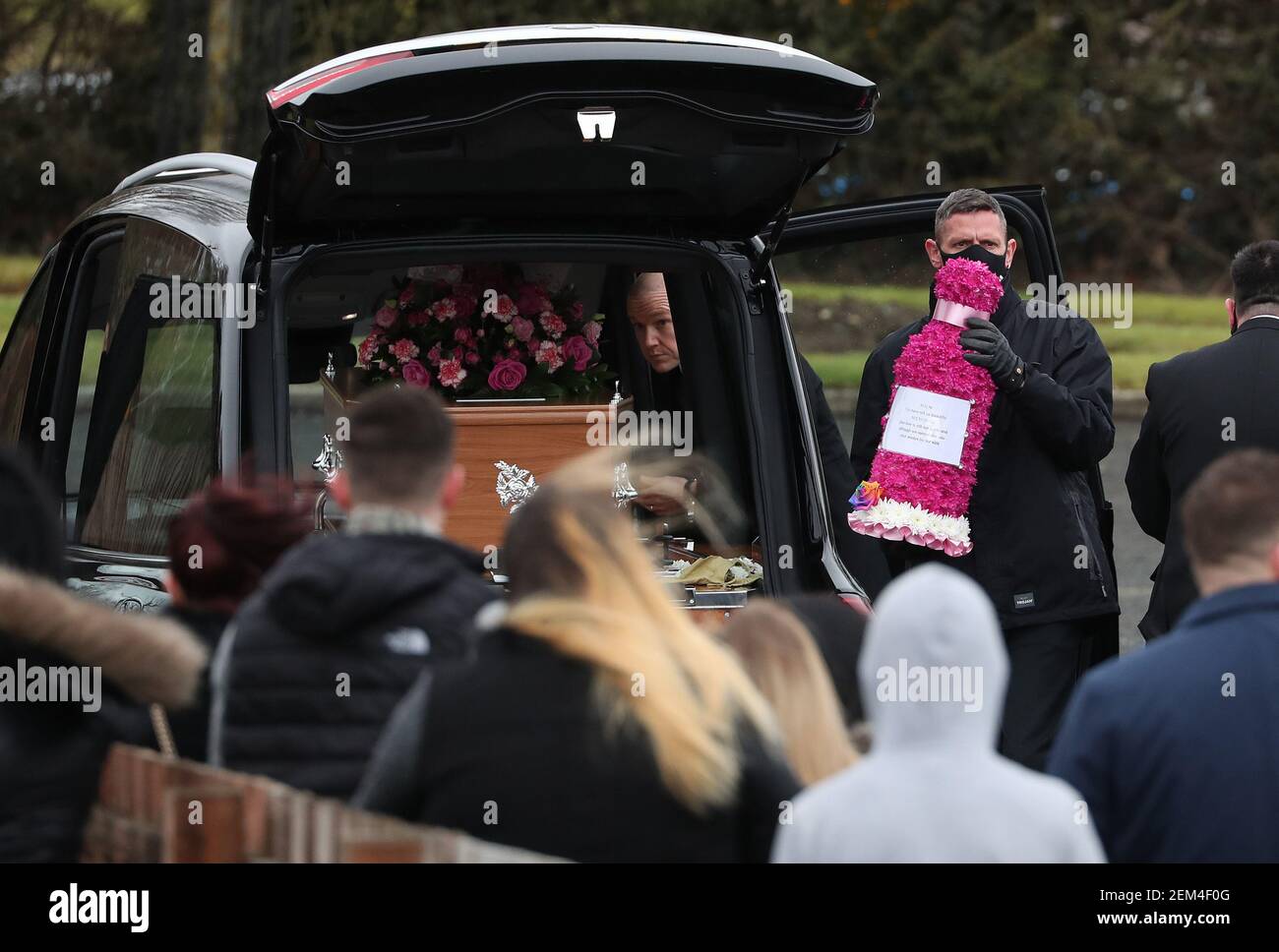 Flowers are carried from the hearse after the funeral cortege of NHS worker Emma Robertson