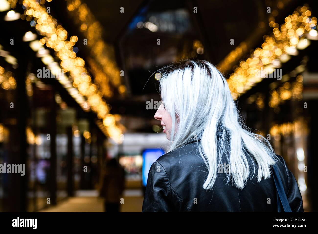Fashion student shopping at Christmas time in London shopping mall. Stock Photo
