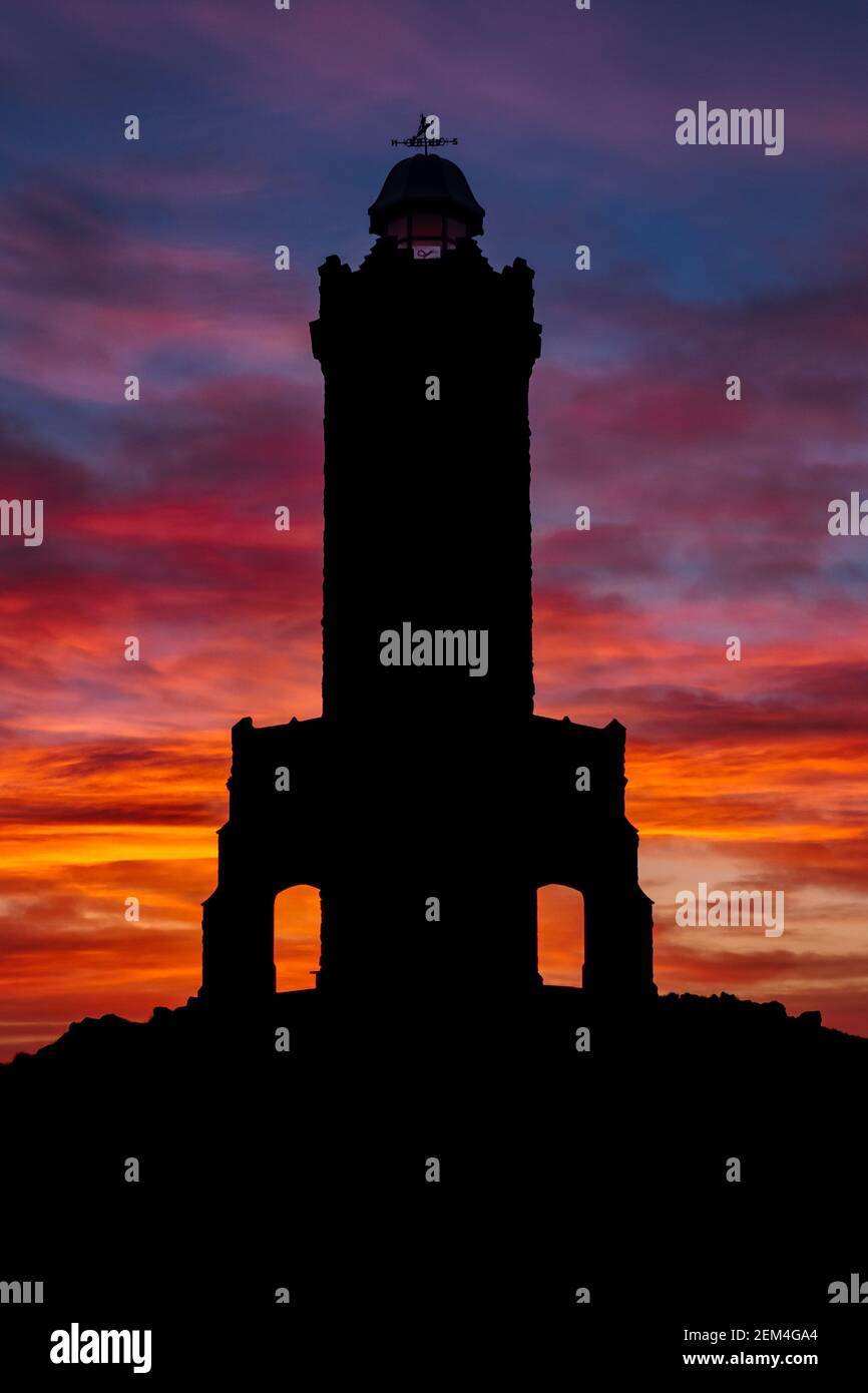 Sunrise at Darwen Tower (Jubliee Tower) - A silhouette of the tower with Deep Red Sky Stock Photo
