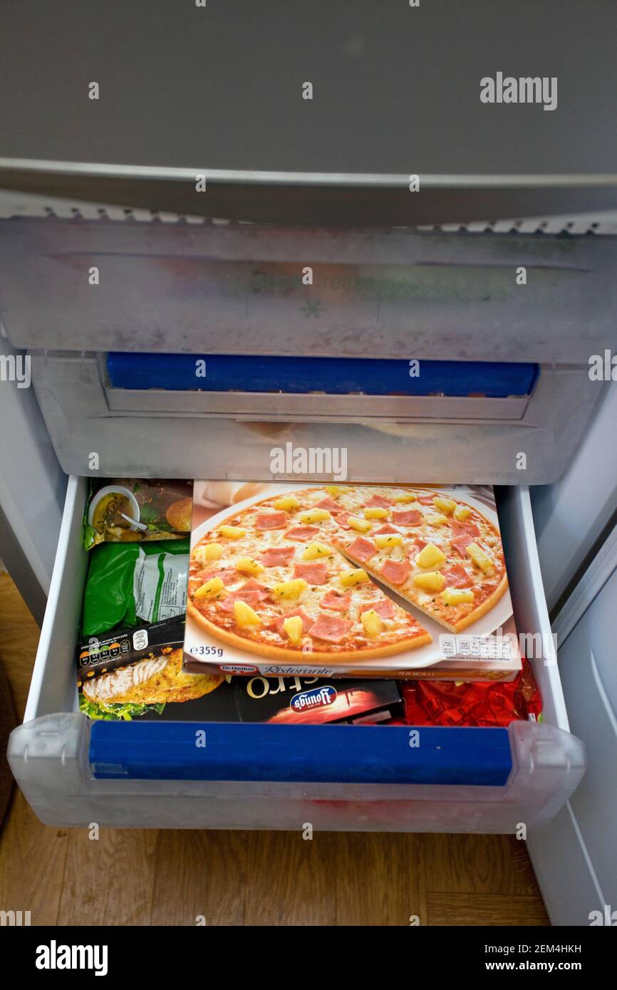Boxed frozen pizza in freezer drawer Stock Photo