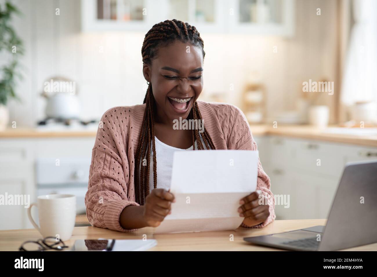 Overjoyed Black Woman Reading Letter In Kitchen And Exclaiming With Excitement Stock Photo