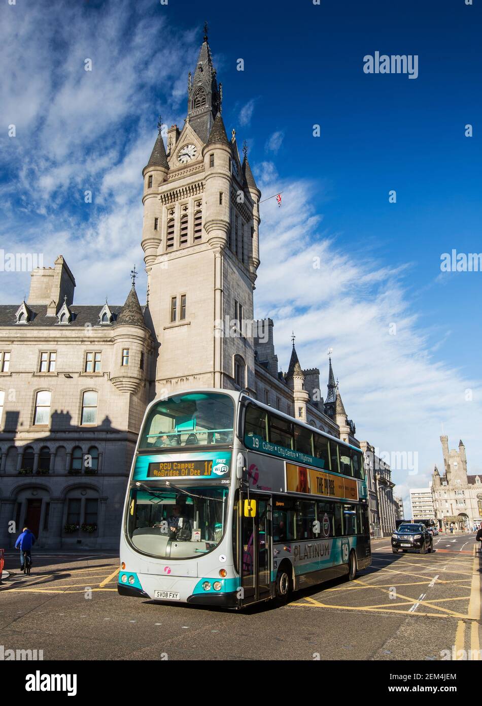 Double decker First bus passes the Town House in Union Street in the city centre of Aberdeen, Scotland Stock Photo