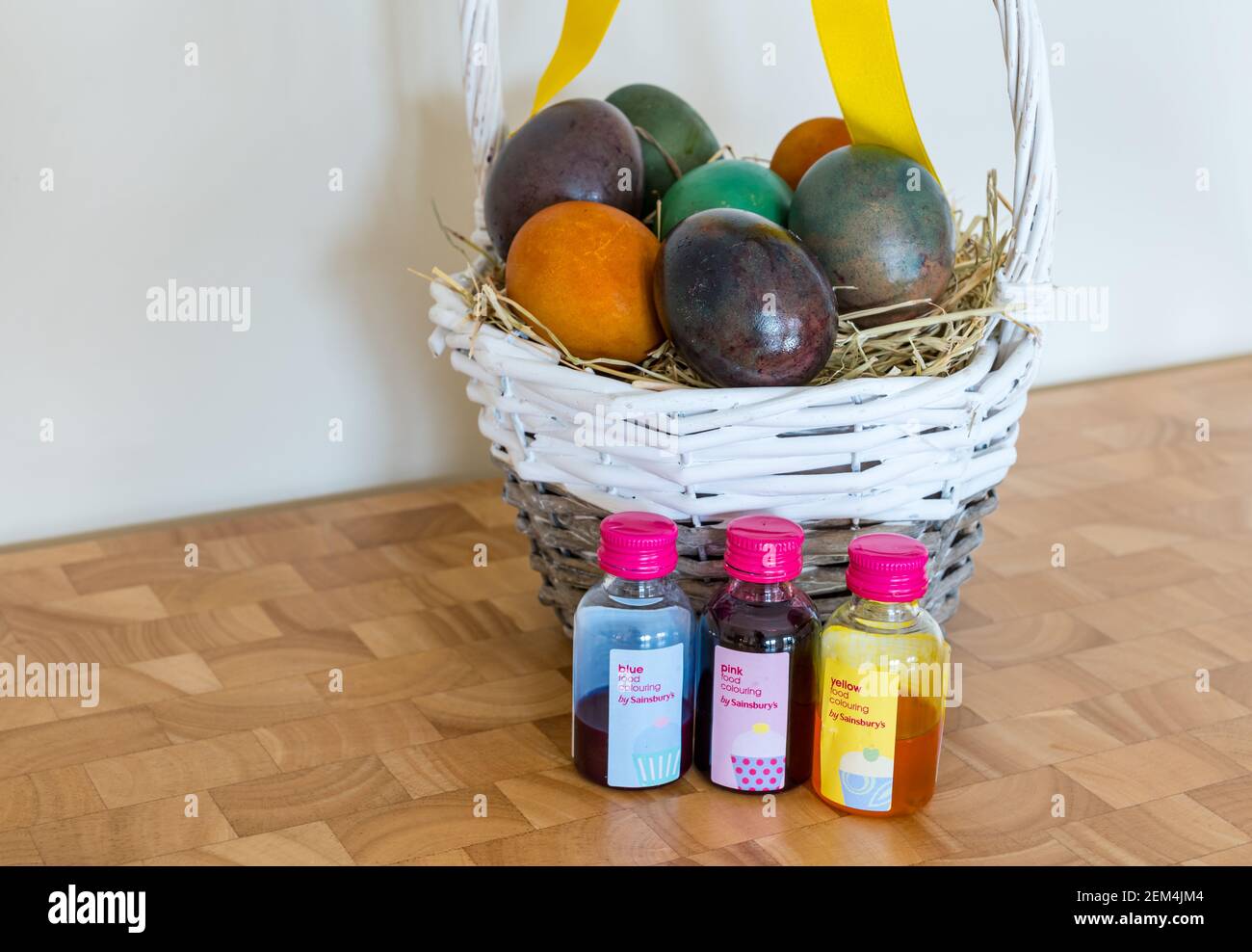 Download Still Life Of Marbled Coloured Easter Eggs In Willow Basket With Yellow Ribbon And Sainsbury S Food Colouring Stock Photo Alamy