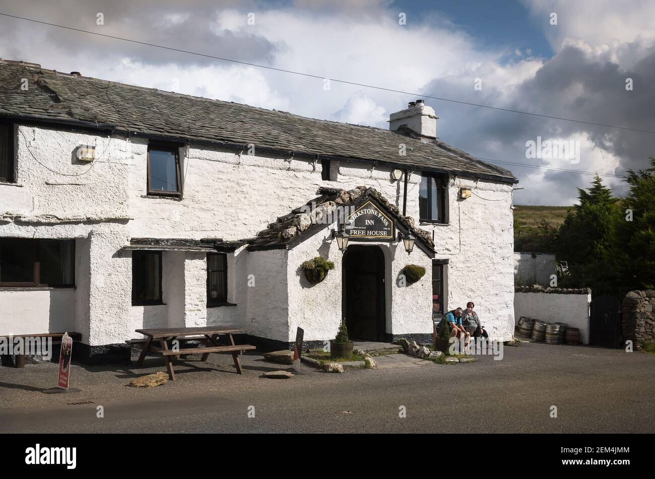 Rain-clouds hover over white-walled  Kirkstone Pass Inn in Cumbria England UK Stock Photo