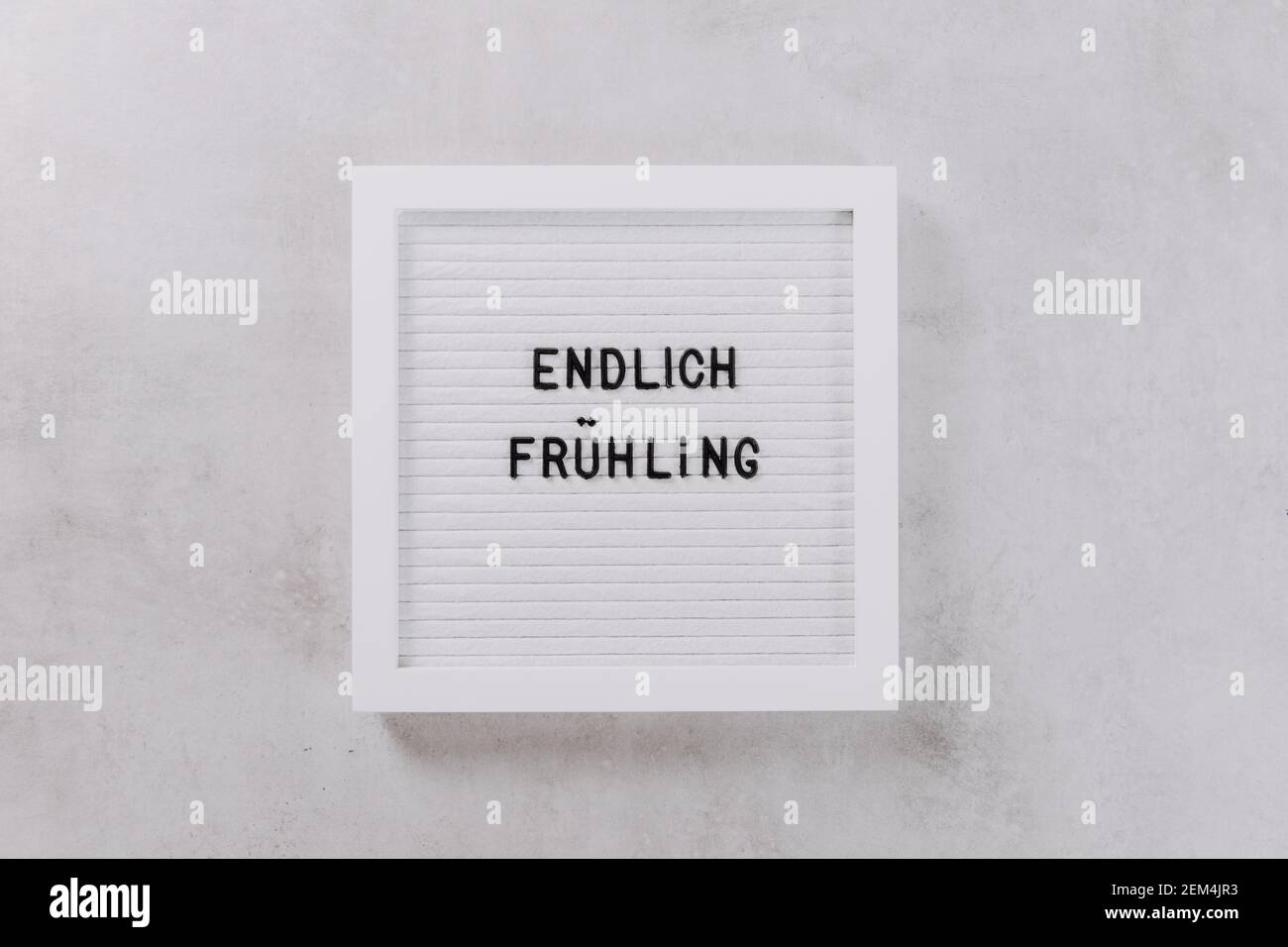 White Letter Board On Grey Background With Words In German Language Endlich Fruhling Meaning Spring Is Here Framed Mockup For Text Stock Photo Alamy