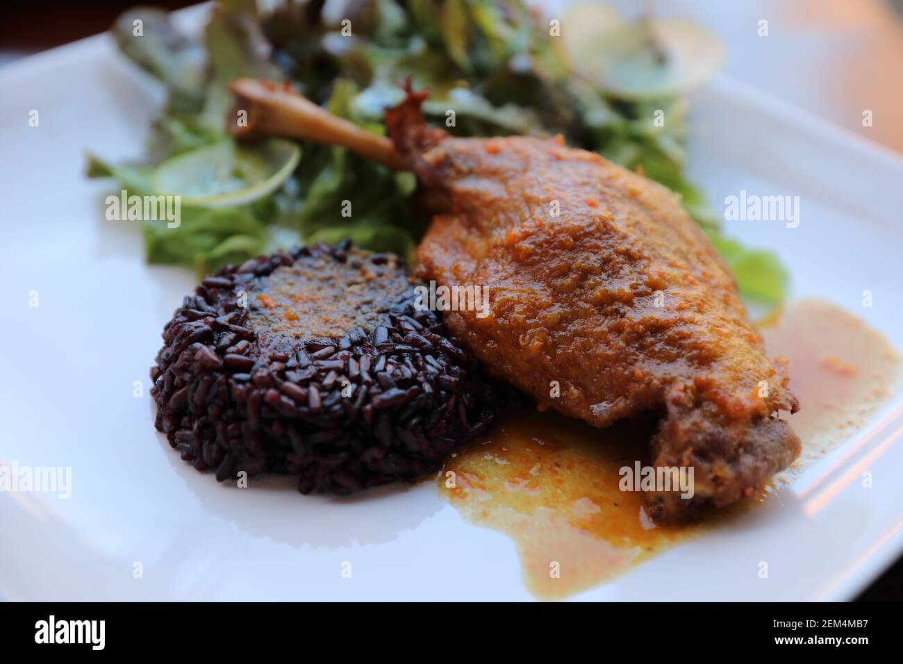 duck confit with rice and salad , italian food style Stock Photo Alamy