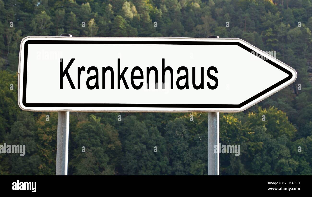 Signpost with the word 'Krankenhaus', translation 'Hospital' Stock Photo