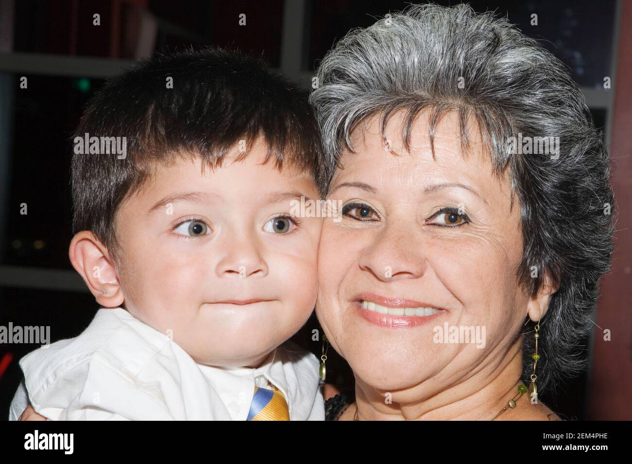 Portrait of a mature woman and her grandson cheek to cheek Stock Photo