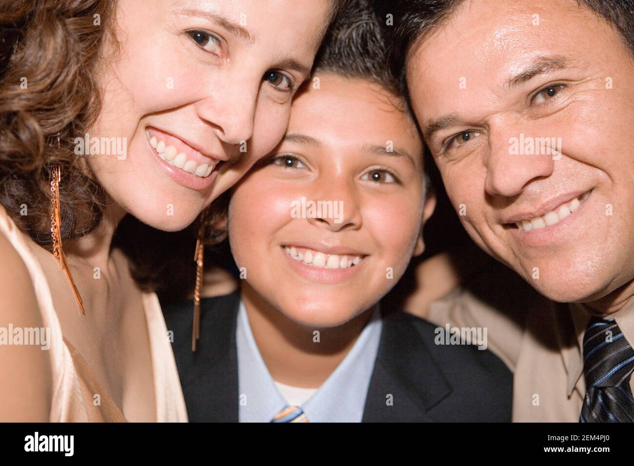 Portrait of a mature man and a mid adult woman smiling with their son Stock Photo