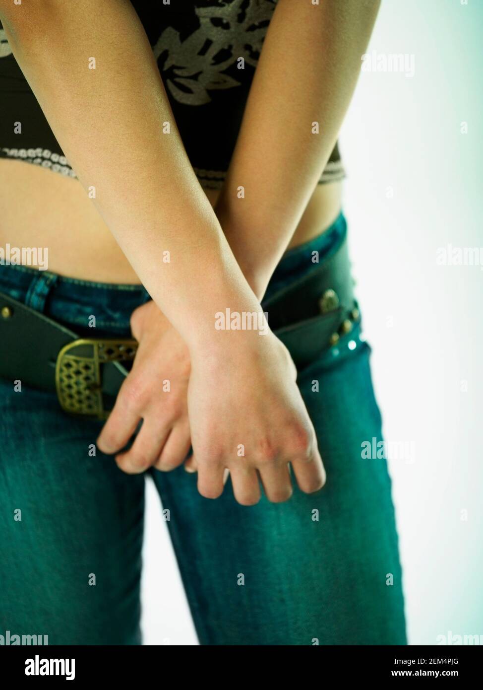 Mid section view of a woman holding her belt Stock Photo