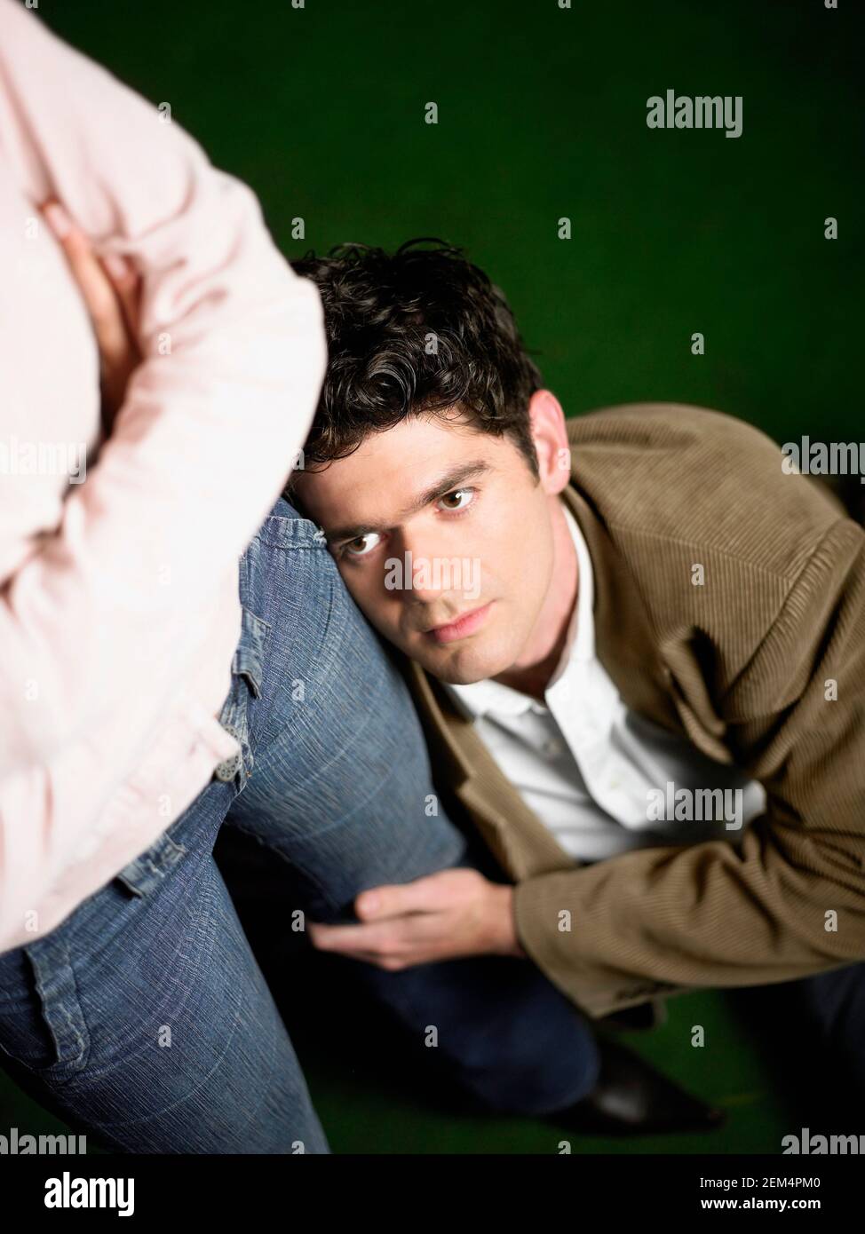 High angle view of a young man holding a woman's leg Stock Photo