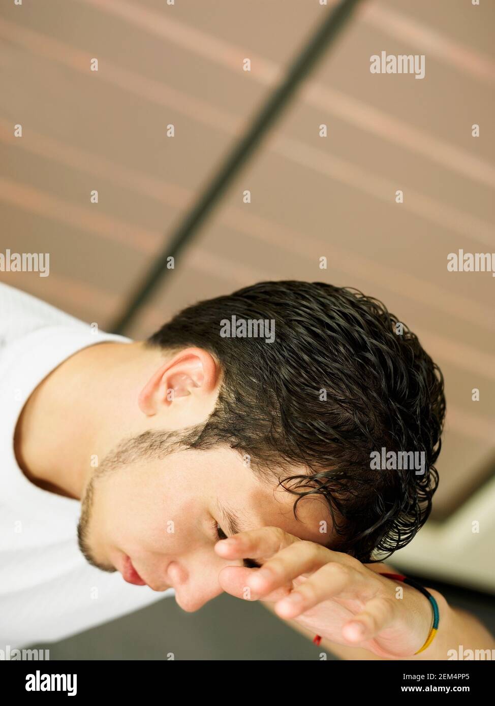 Close-up of a young man looking tired Stock Photo