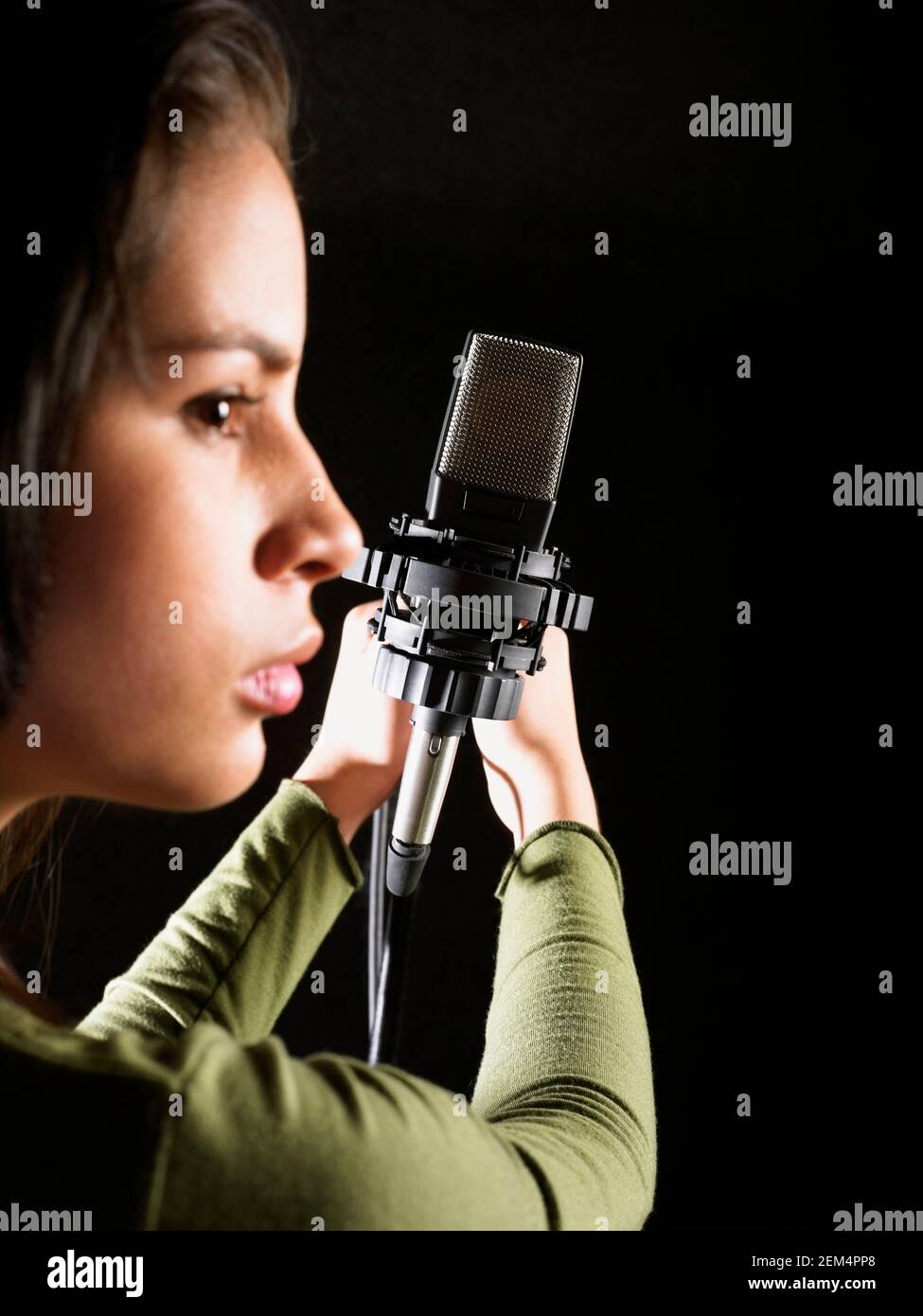 Close-up of a young woman holding a microphone Stock Photo