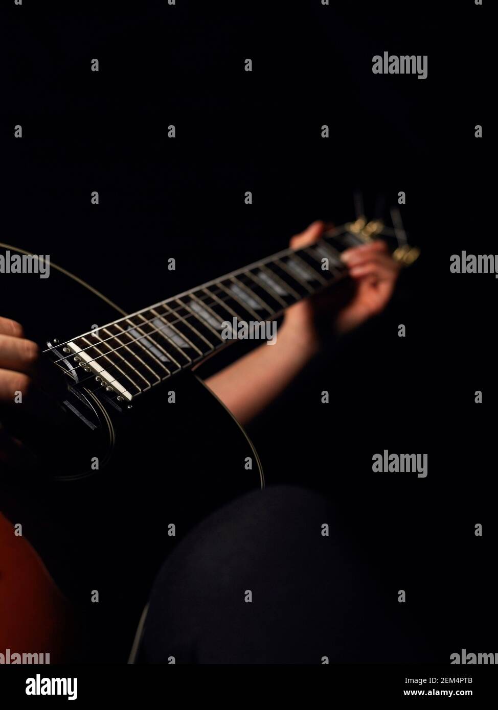 Close-up of a person's hands playing a guitar Stock Photo