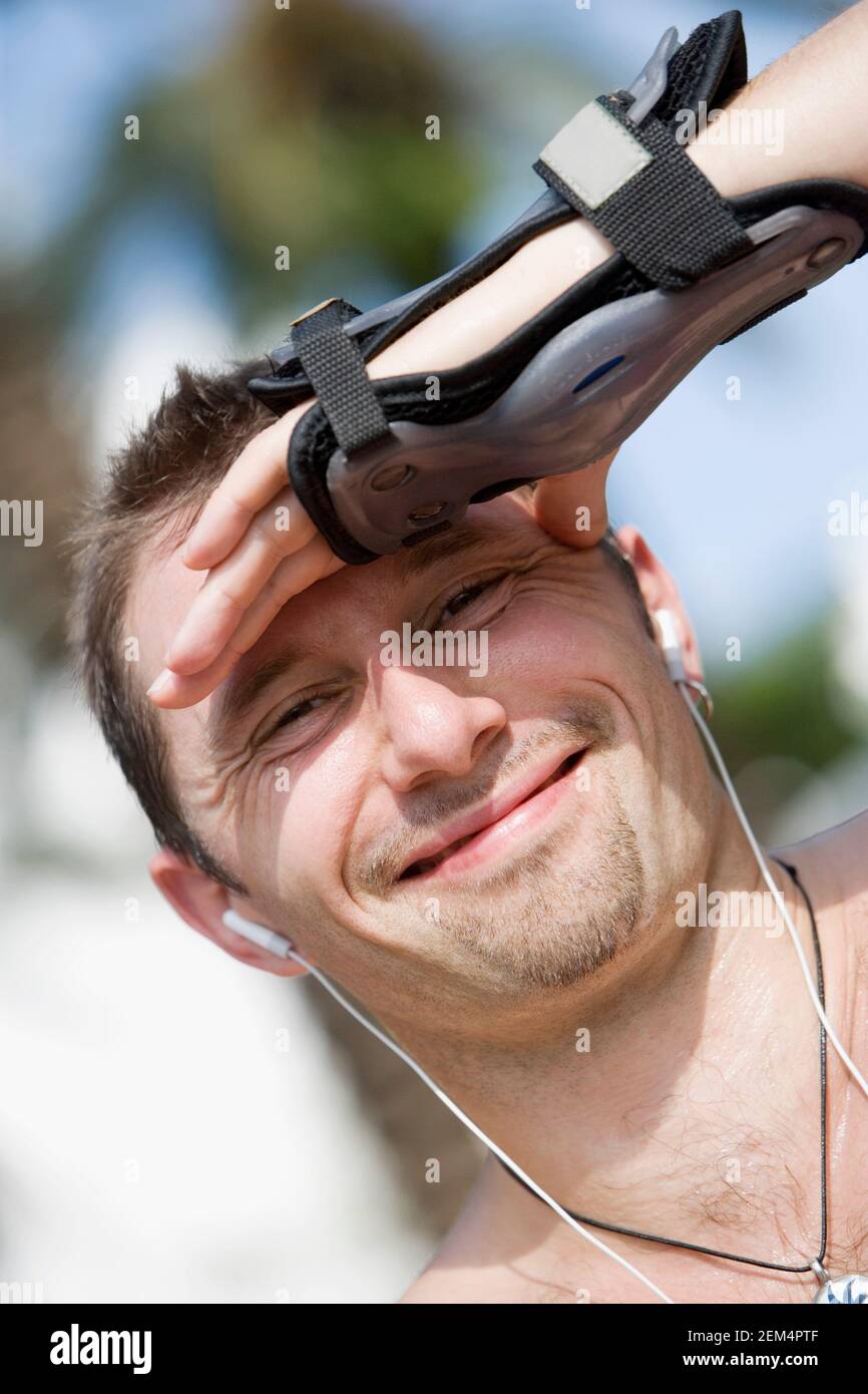 Portrait of a mid adult man shielding his eyes Stock Photo